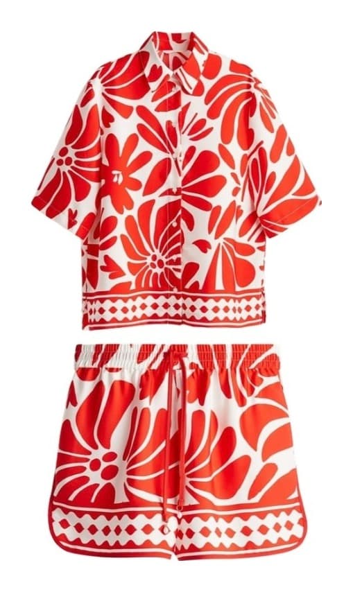 Flat-lay product photo of a cream short-sleeve shirt with a green and pink floral print.