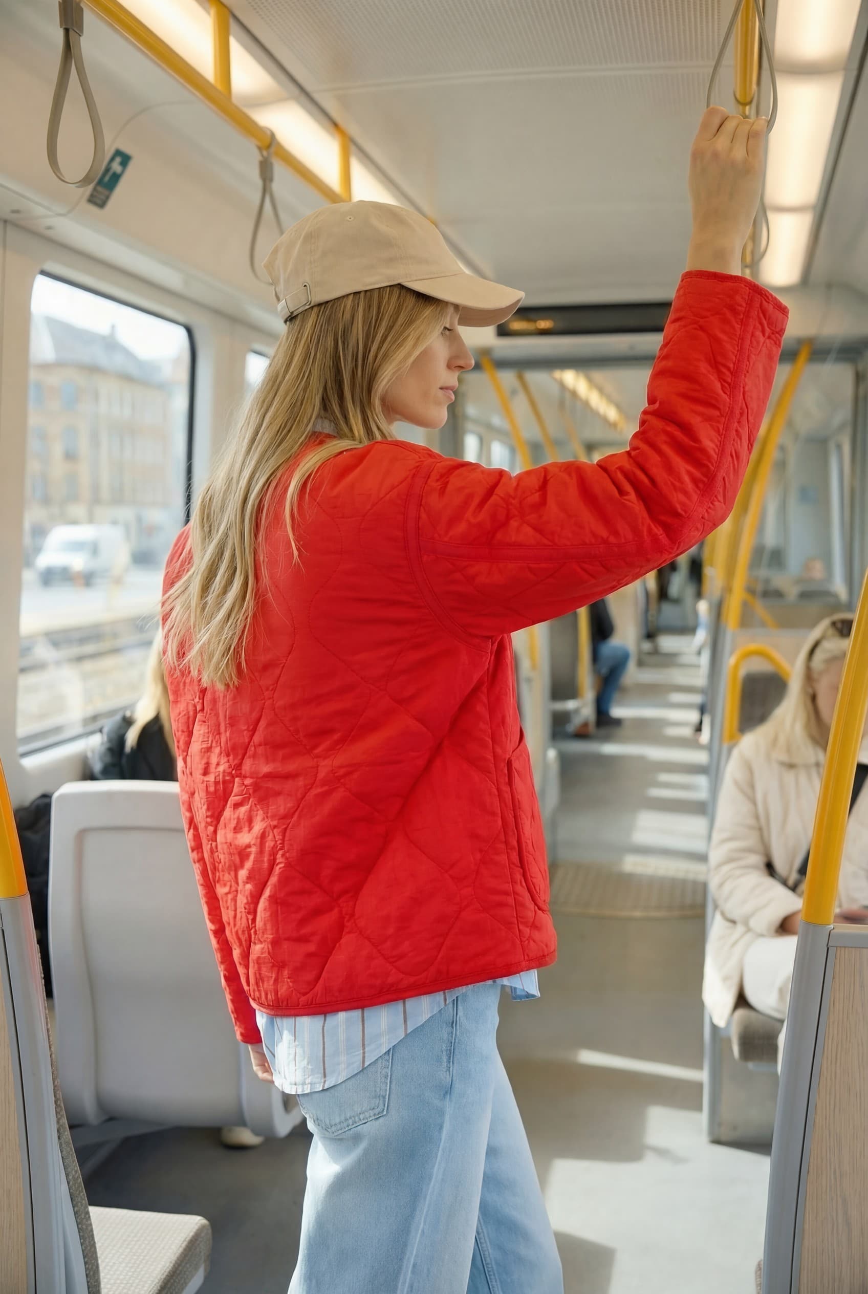 Rear PDP-style view of a model wearing a red quilted jacket