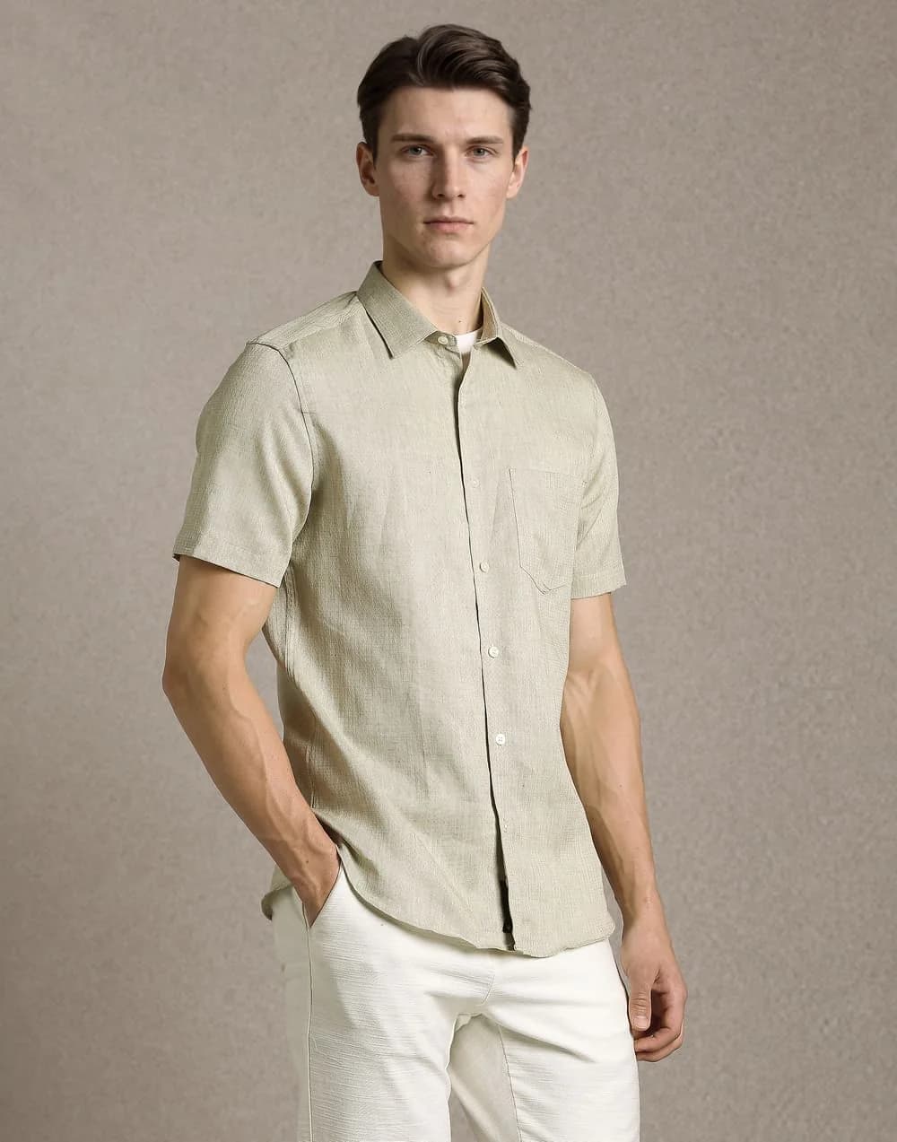Male fashion model in a light short-sleeve shirt and white trousers.